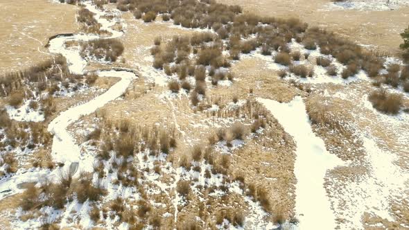 Aerial view of small mountain creek  in the Winter.