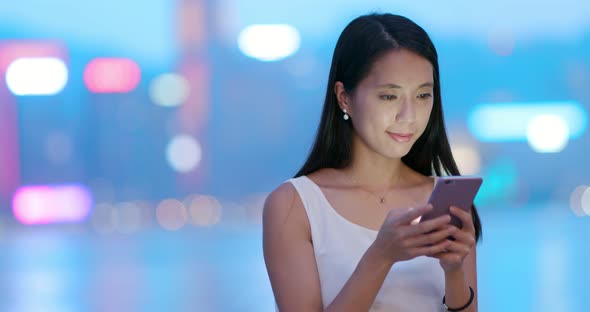 Woman use of mobile phone at night