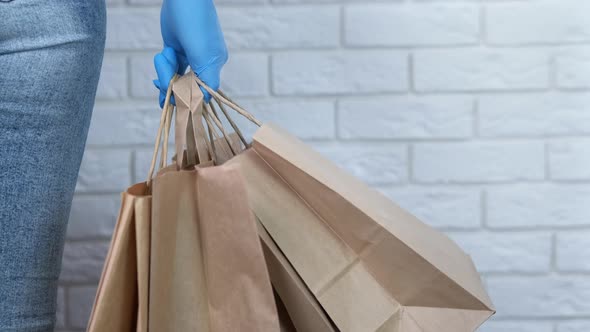 Female in Gloves with Paper Bag