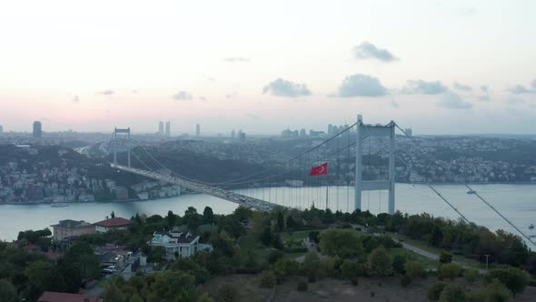 Turkish Flag Waving in Wind in Front of Istanbul Bosphorus Bridge and City Skyline at Beautiful