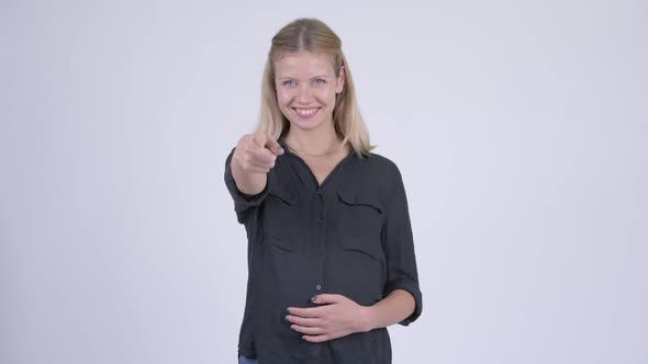 Young Happy Pregnant Businesswoman Pointing at Camera