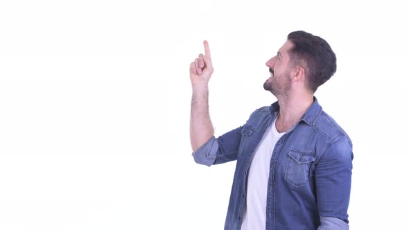 Happy Young Bearded Hipster Man Thinking and Pointing Up