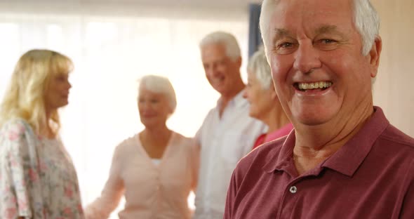 Portrait of happy senior man spending time with his friends