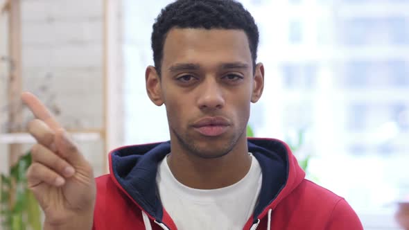 Portrait of AfroAmerican Man Waving Finger to Refuse