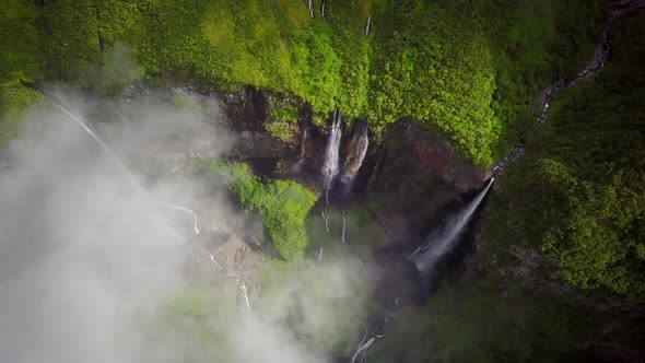 Aerial view of waterfalls and people canyoneering in Reunion island.