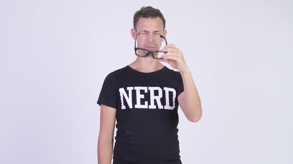 Studio Shot of Nerd Man Cleaning Eyeglasses