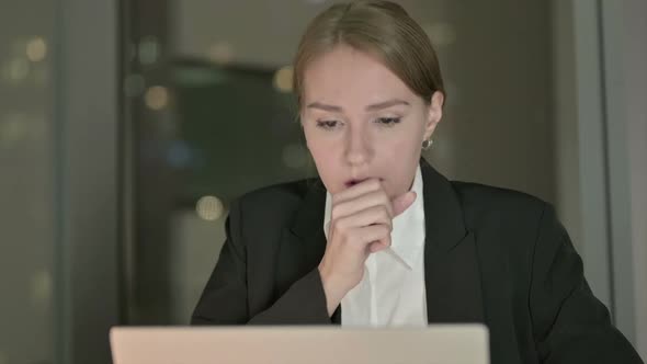 Close Up of Sick Businesswoman Coughing on Office Desk at Night