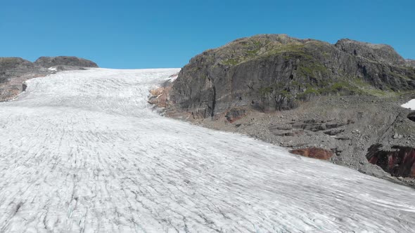 Aerial: receding glacier in Norway mountains, global warming climate change