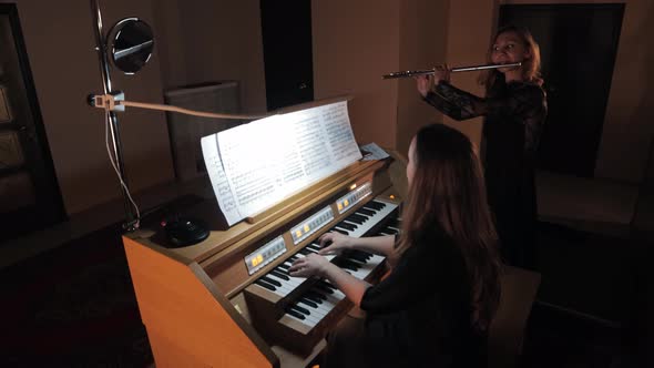 Female Flutist Playing Music on Electronic Organ and Flute