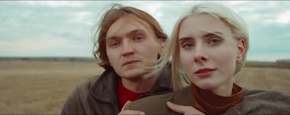 Portrait of Romantic Couple on Autumn Field