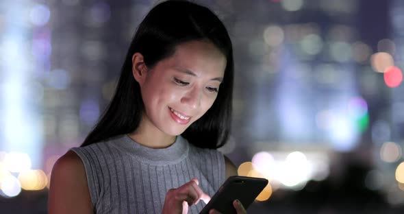 Woman using mobile phone in Hong Kong 