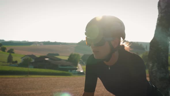 Portrait of woman on bicycle at sunset