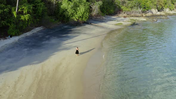 Woman Running on the Empty Tropical Beach Aerial Drone Shot