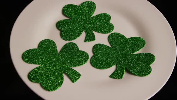 Rotating stock footage shot of St Patty's Day clovers on a white surface - ST PATTYS 004