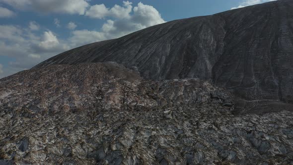 a Young Wedding Couple Stands on a Salt mountain.The Wind Blows the Veil. Against the Background of