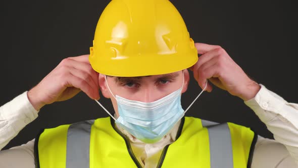 Worker Wearing Medical Mask Wearing Safety Equipment Hard Hat and Vest