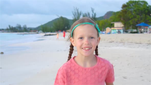 Cute Little Girl in Hat at Beach During Caribbean Vacation