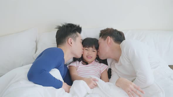 Portrait of handsome man gay family with young kid daughter in bedroom.