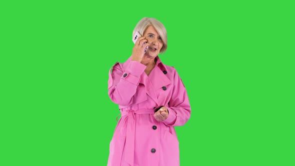 Grandmother Calling Loving Fashionable Modern Grandmother Wearing Pink Trench Coat Making a Call on