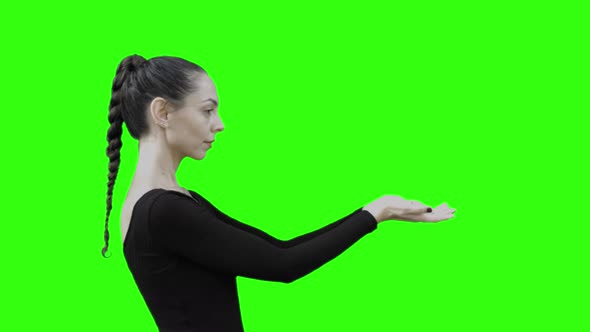 Young Woman looking at a Virtual Entity with Green Screen.