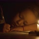 Closeup of Child Girl is Writing By Pen in Candlelight at Darken Room - VideoHive Item for Sale