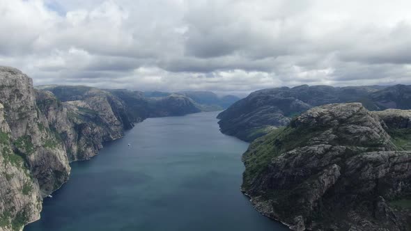 Panoramic Aerial View of a Massive River with a Sailing Yacht Between Mountains