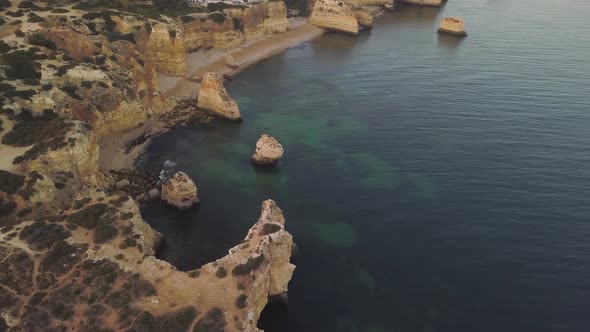 Stunning panorama of cliffs of Marinha beach in Algarve, aerial shot