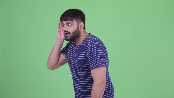 Stressed Young Overweight Bearded Indian Man Listening and Getting Bad News