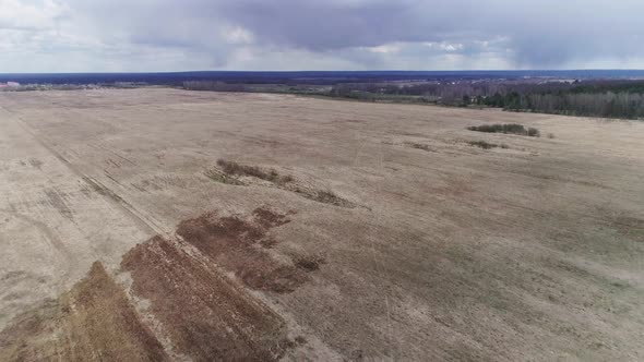 Flying Over an Empty Field. Early Spring, a Lot of Withered Grass