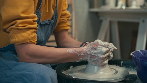 Close-up Shot of a Woman's Hands Making Ceramic Pottery on the Pottery Wheel.