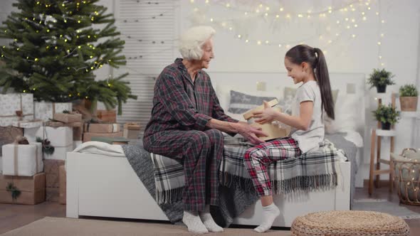 Happy Little Girl Opening Christmas Present