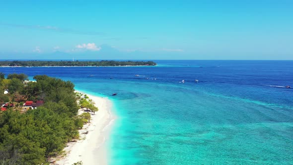 Beautiful flying abstract shot of a summer white paradise sand beach and blue ocean background in co