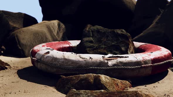 Old Life Buoy on Sandy Beach