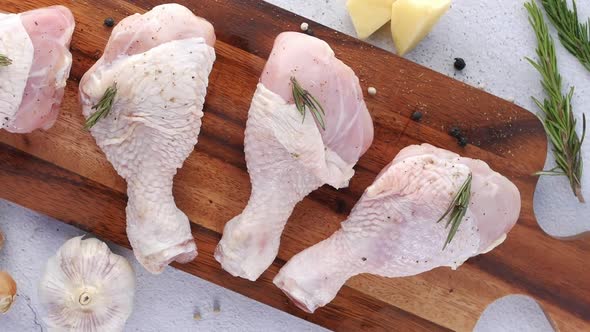 Raw Chicken Drumstick on a Chopping Board