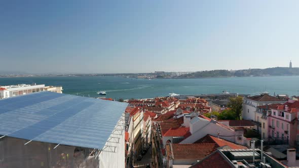 Aerial Dolly in View of Red Rooftops of Traditional Colorful European Buildings and Boats at Sea Off