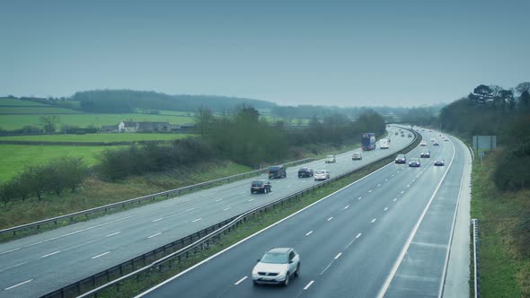 Many Cars Passing On Highway In The Countryside