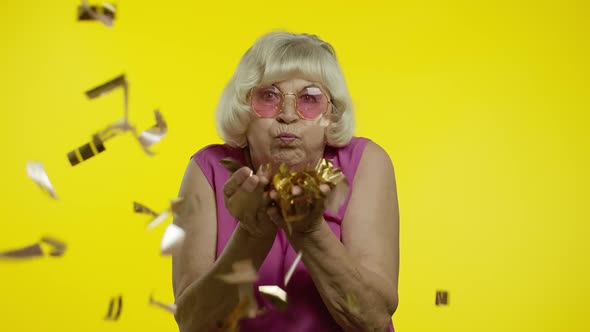 Happy Senior Old Woman Laughing, Blowing Confetti Glitters, Celebrating Birthday, Winning Lottery