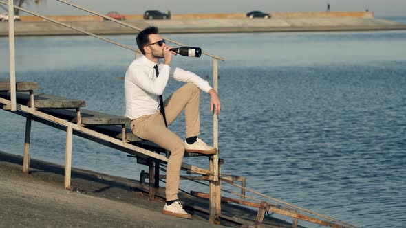 Man Drink Champagne And Relaxing Near River. Businessman Relaxing And Drinking Wine.