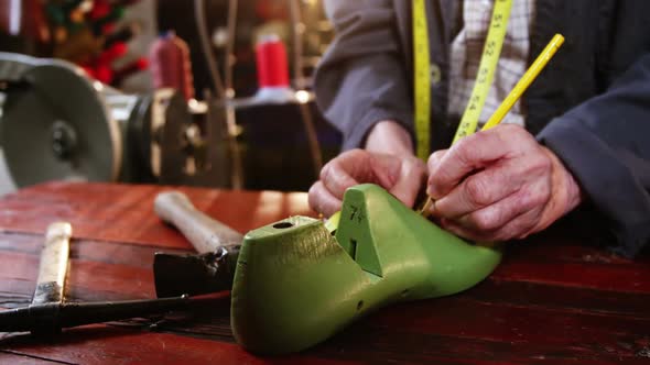 Shoemaker marking on shoe last with pen