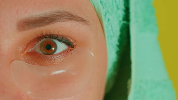 Young Woman with Towel on Head and Patches Under Her Eyes