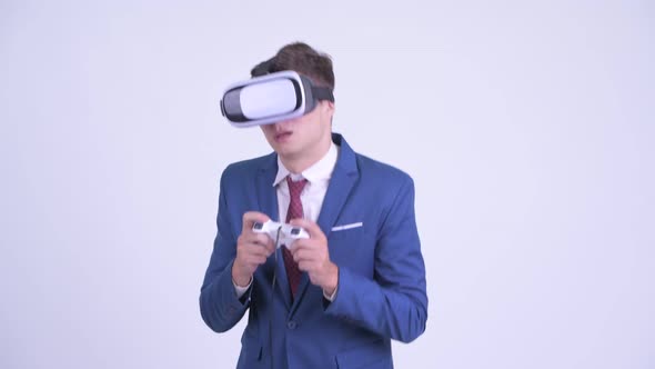Young Handsome Businessman Playing Games with Virtual Reality Headset
