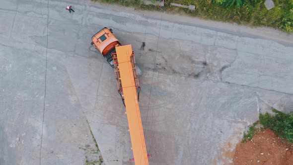 Transporting Orange Parts of Lifting Cranes on the Truck Outdoor From the Plant