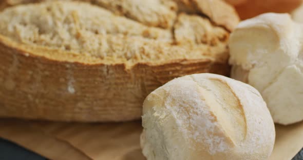 Video of bread on chopping wooden board on wooden worktop