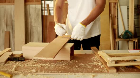 Woodwork and furniture making concept. Stylish craftsman working in his carpentry workshop