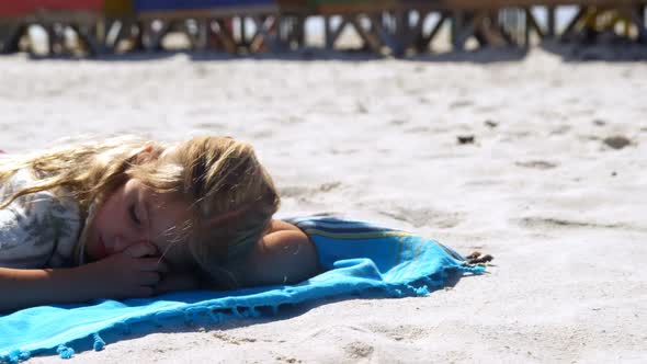 Girl sleeping in the beach 