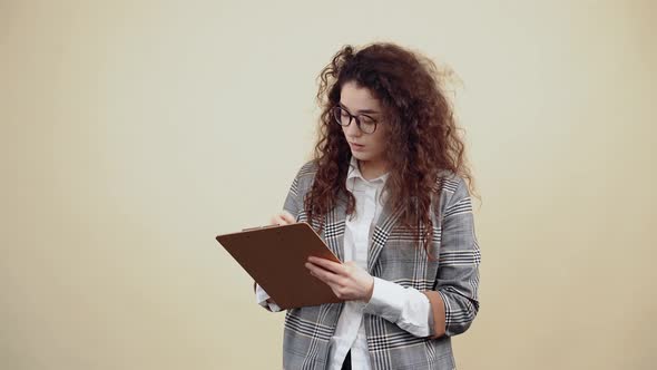 Creative Thoughtful Hooded Young Woman Thinking About the Future Business Plan Taking Notes in the