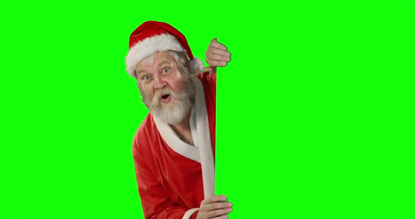 Surprised santa claus waving hand on green screen