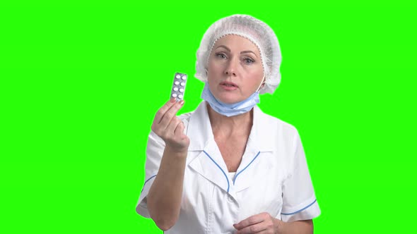 Lady Doctor with Pills on Green Screen.
