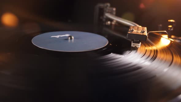 Rotating Vinyl Record Scratched with a Metal Needle on a Gramophone.