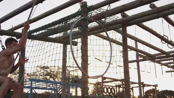 Young man training at an outdoor gym bootcamp